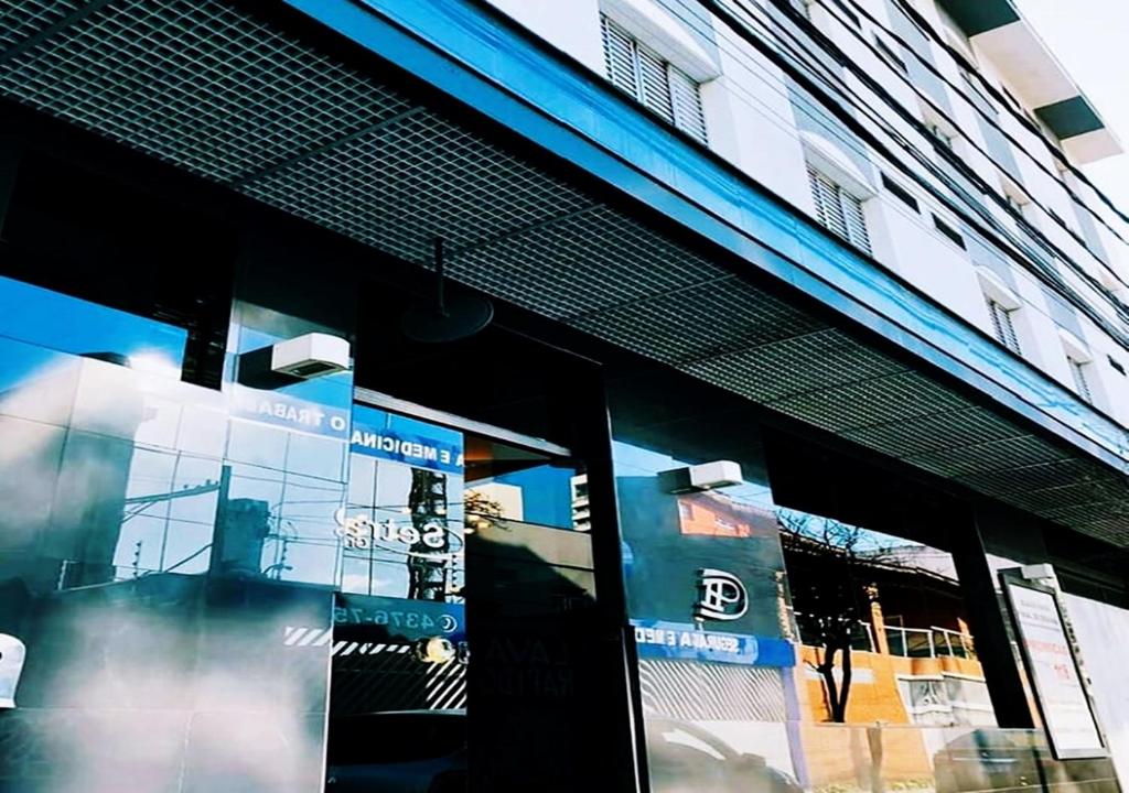 a store front window of a building with signs in it at David Plaza Hotel in Osasco