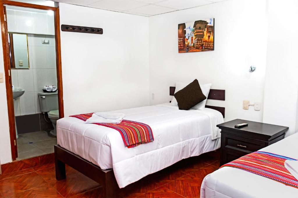 Postel nebo postele na pokoji v ubytování Peru Coca B&B Machupicchu
