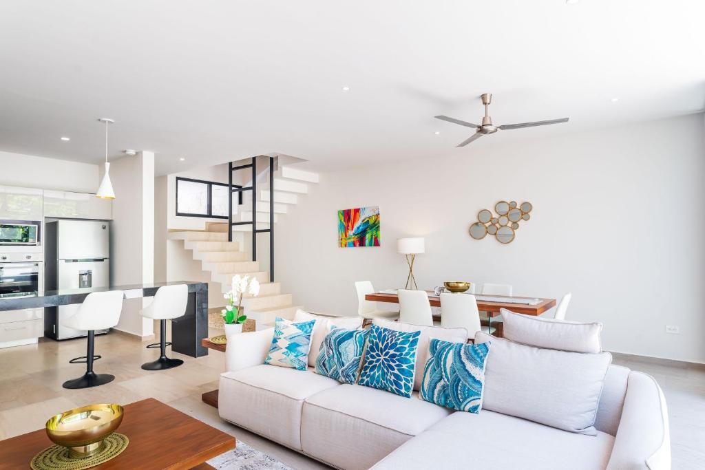 a living room with a white couch and a table at Entire House- 3BR with Private Roof Top Deck in Playa del Carmen