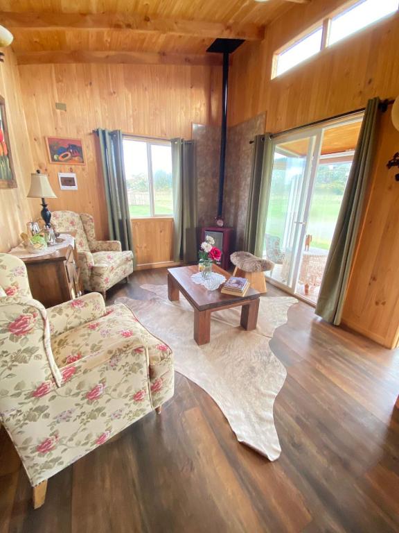 a living room with a couch and a table at Cabañas Teresa Frutillar in Frutillar