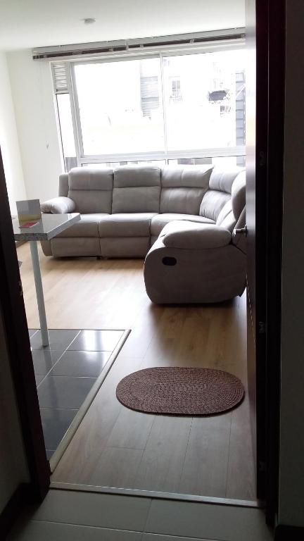 uma sala de estar com um sofá e um tapete em Apartaestudio Sector Hayuelos em Bogotá