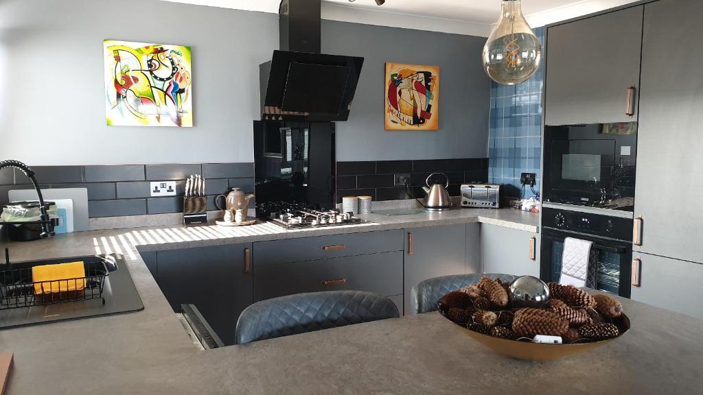 a kitchen with a table with a bowl of food on it at Holiday Apartment, Balloch, Loch Lomond in Balloch