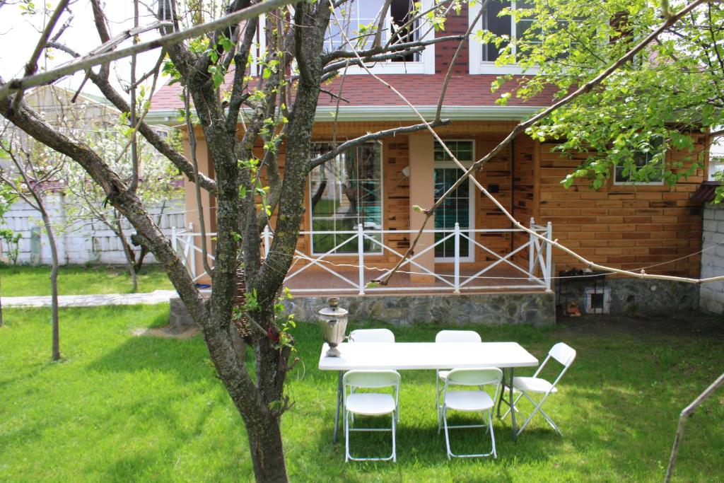 a table and chairs in the yard of a house at Green Garden Gabala Villas&Cottages in Gabala