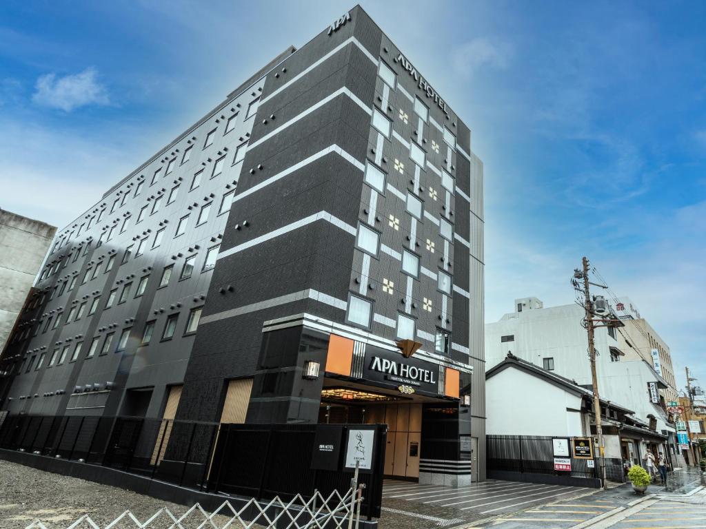 a tall black building with a sign on it at APA Hotel Kintetsu Nara Ekimae in Nara