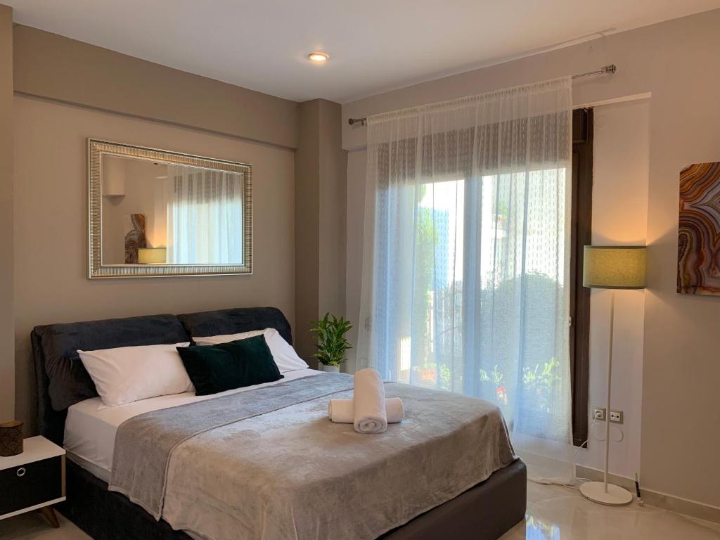 a bedroom with a bed with a large window at Antony Luxury Suite in Thessaloniki in Thessaloniki