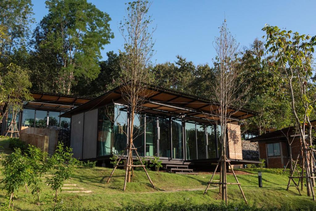 a glass house with trees in front of it at Huaysompoi Valley Nan in Nan