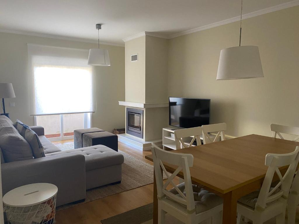 a living room with a couch and a dining room table at Lenda do Mar in Vila Chã