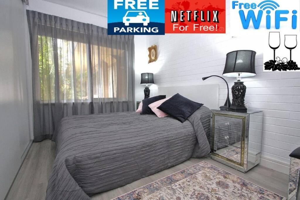a bedroom with a bed with a nightstand and a window at LOCATION LIFESTYLE CONVENIENCE! WIFI NETFLIX WINE in Perth