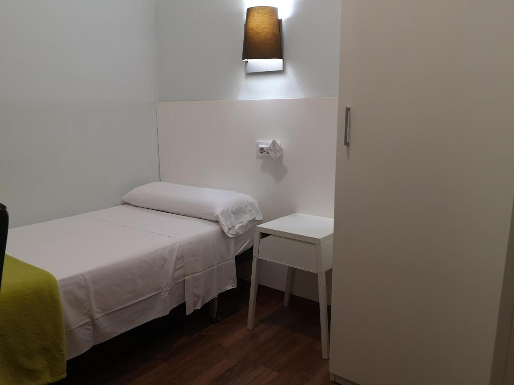 Posteľ alebo postele v izbe v ubytovaní Hostal Lesseps