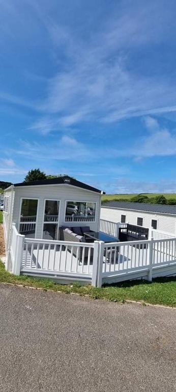 a white fence in front of a house at PV70 newquay bay resort in Newquay Bay Resort