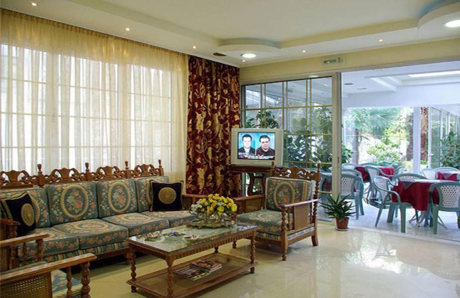 a living room with a couch and a table at Hotel Chronis in Paralia Katerinis