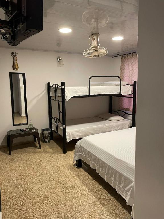 Postel nebo postele na pokoji v ubytování BOUTIQUE HOTEL BALOP Valledupar