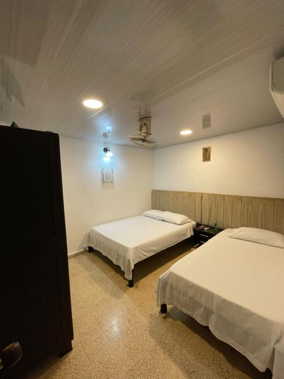 Postel nebo postele na pokoji v ubytování BOUTIQUE HOTEL BALOP Valledupar