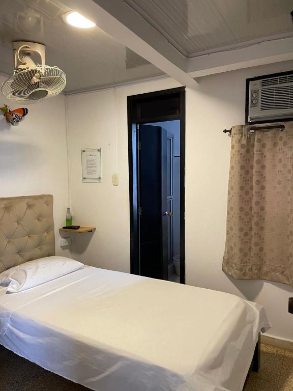 Postel nebo postele na pokoji v ubytování BOUTIQUE HOTEL BALOP Valledupar