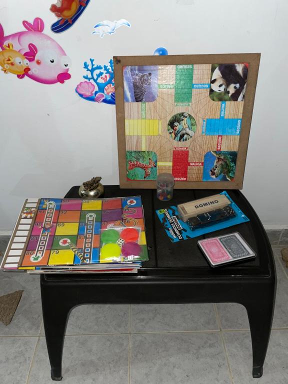 a table with books and other items on it at Alojamiento in Bahía Solano