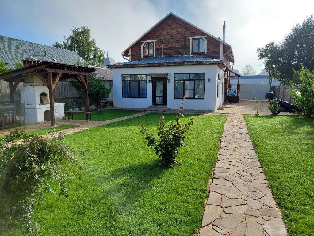 a house with a grass yard with a pathway at Suzdal Like Home in Suzdal