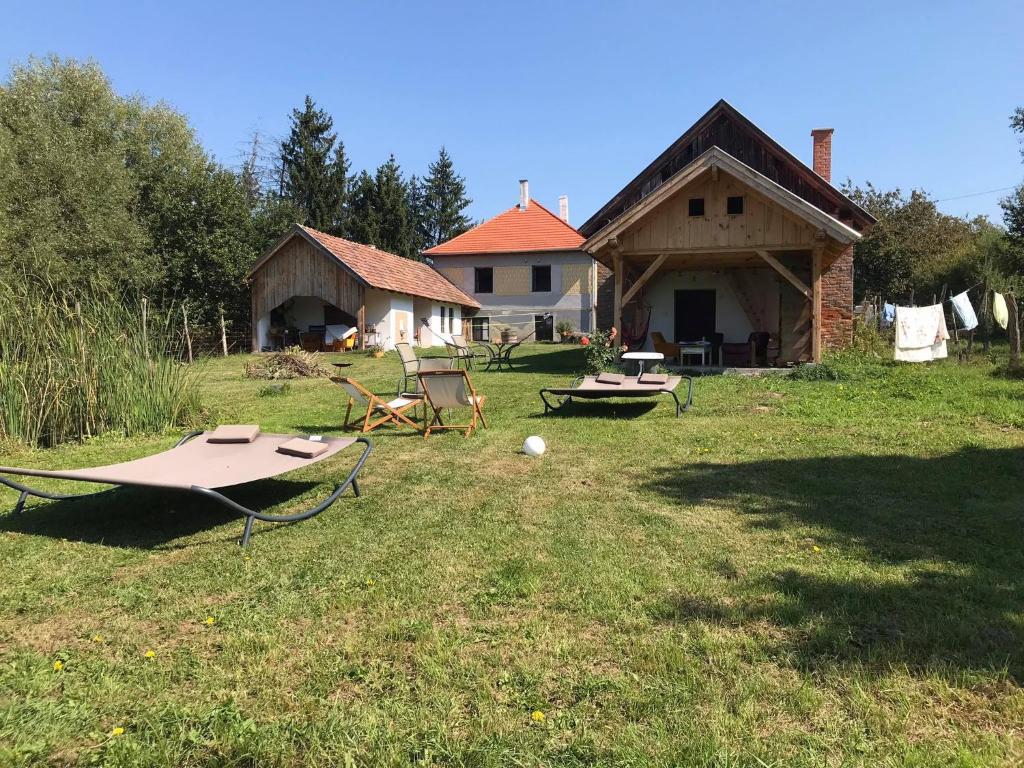 Szalafő的住宿－100 Bárányos，一个带野餐桌和房子的院子