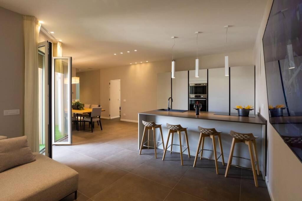 a kitchen with a counter and stools in a room at cefalù luxury appartament in Cefalù