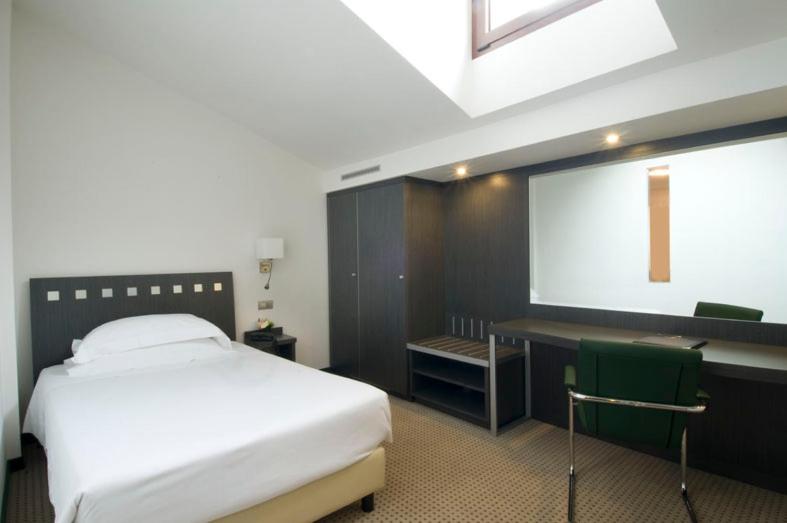 Postel nebo postele na pokoji v ubytování Arli Hotel Business and Wellness