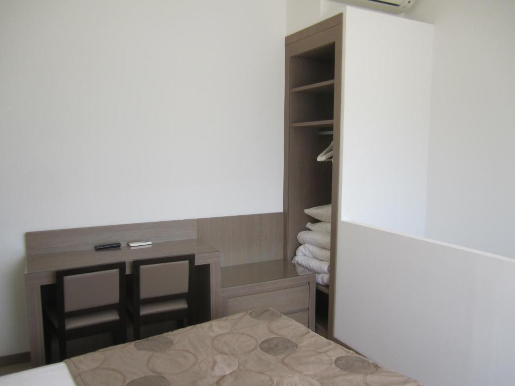 Postel nebo postele na pokoji v ubytování Hôtel Le Rocher