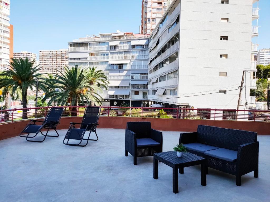 a group of chairs and tables on a roof at COBLANCA 5 HOLIDAYS & RELAX in Benidorm