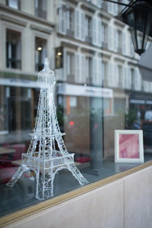 a model of the eiffel tower in a window at Hôtel Royal Opéra in Paris