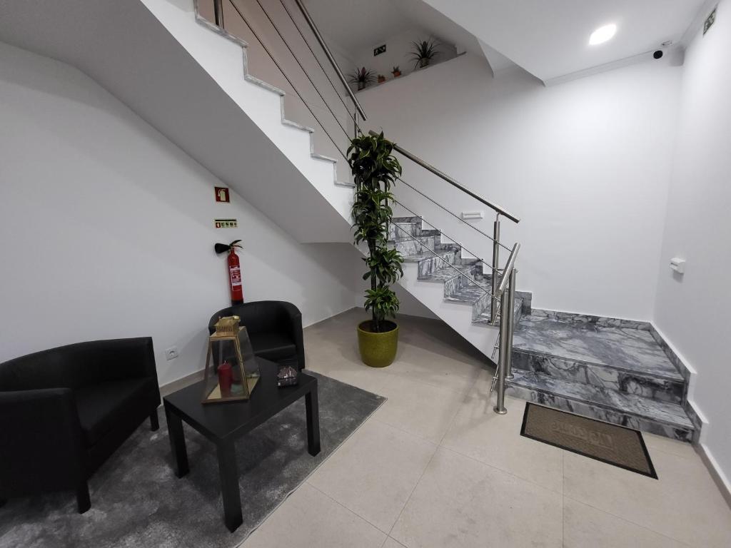a living room with a staircase and a table at Casa Borges in Charneca