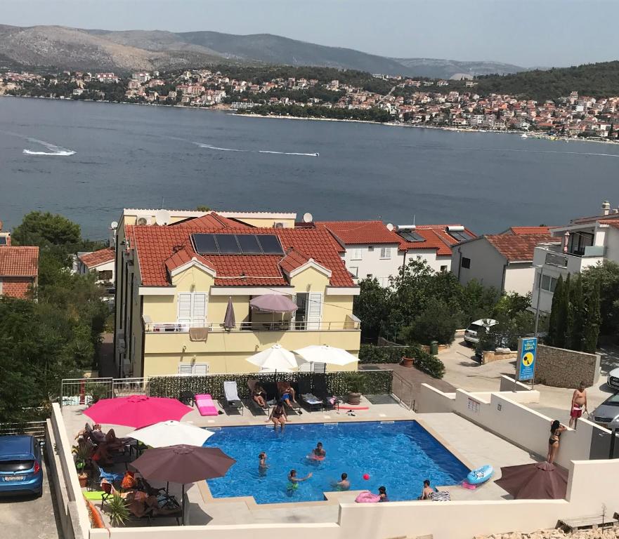 a swimming pool with a view of the water at Villa Luna in Trogir