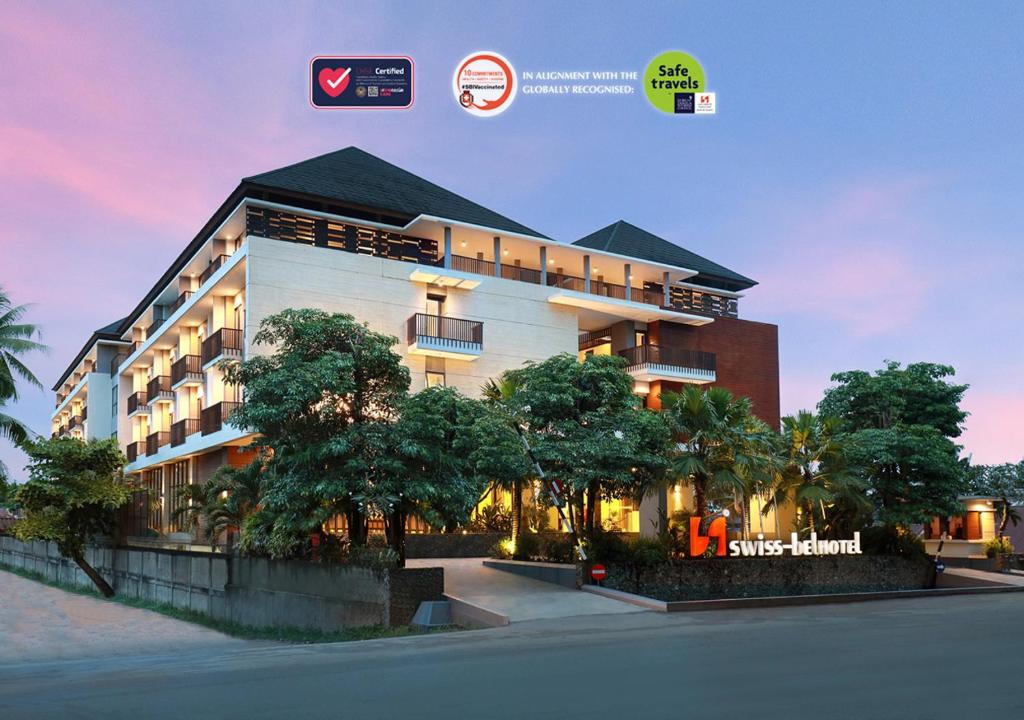 a large building with trees in front of it at Swiss-Belhotel Sorong in Sorong