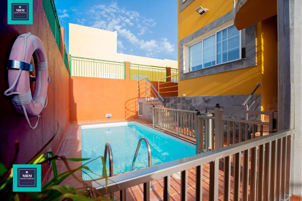 a swimming pool on the side of a building at Inés Apartment, Montaña La Data in San Bartolomé de Tirajana