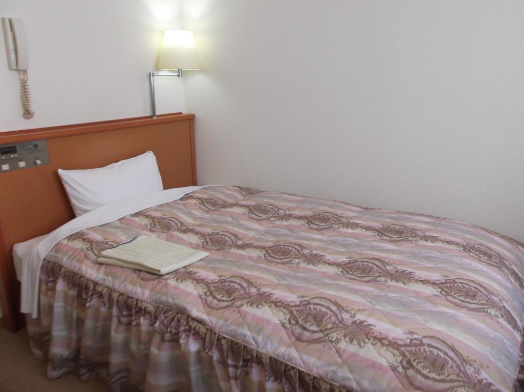 Postel nebo postele na pokoji v ubytování Hotel Sunrise21