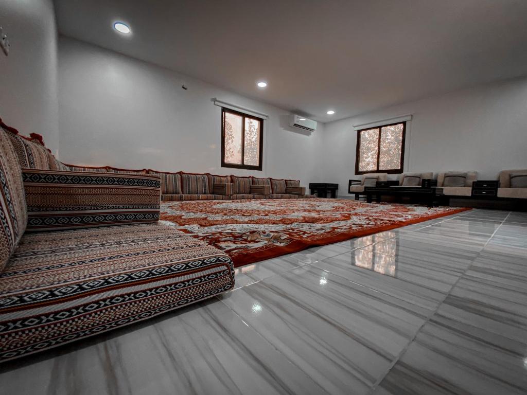 a large room with a couch and chairs in it at Desert Dune Farmhouse - By Seven Elements in Ras al Khaimah
