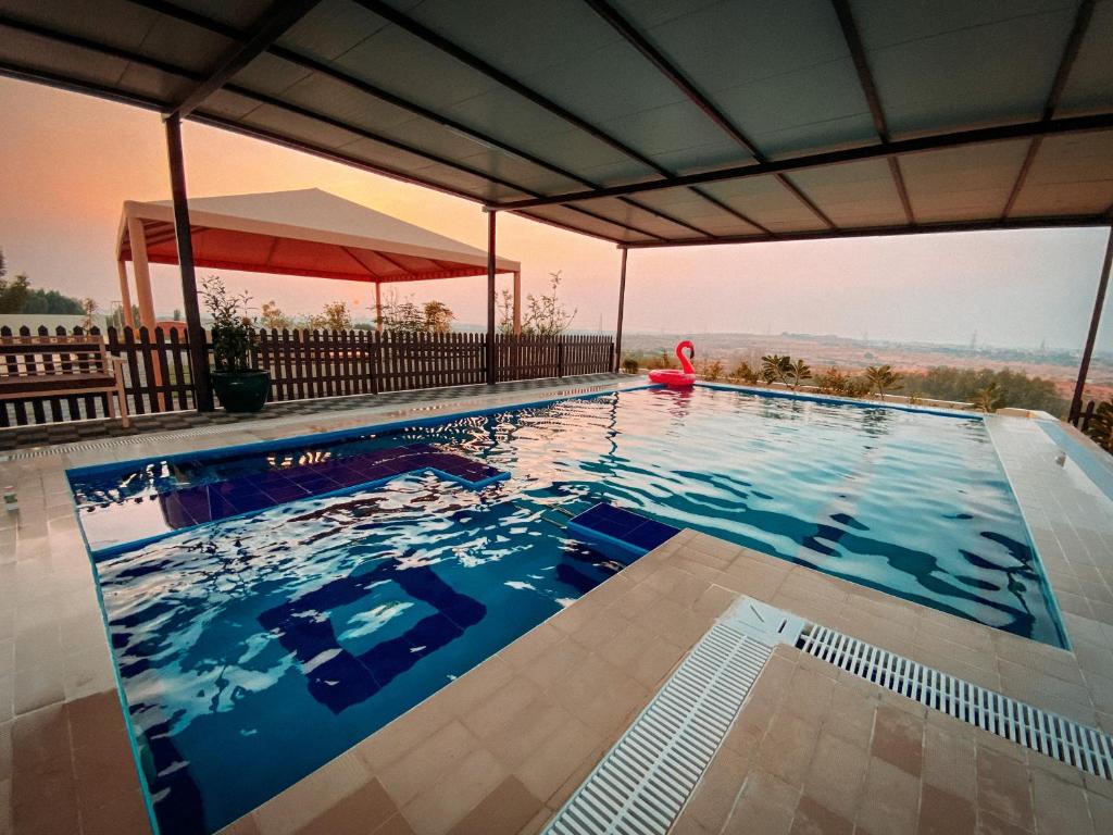 a swimming pool with a view of the desert at Desert Dune Farmhouse - By Seven Elements in Ras al Khaimah
