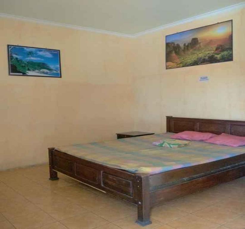 Ліжко або ліжка в номері OYO 90627 Hotel Mutiara