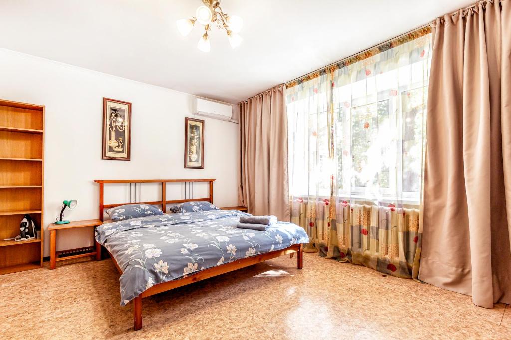 a bedroom with a bed and a large window at 425 Апартаменты в Золотом квадрате в центре Отлично подходят для командированных и туристов in Almaty