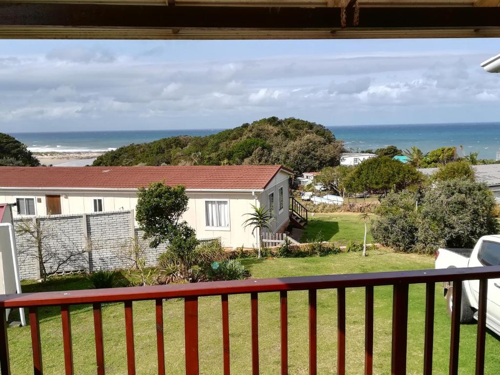 a view of the ocean from the balcony of a house at 2 Bedroom Guest Suite at A-frame Glengariff Beach in Glen Eden