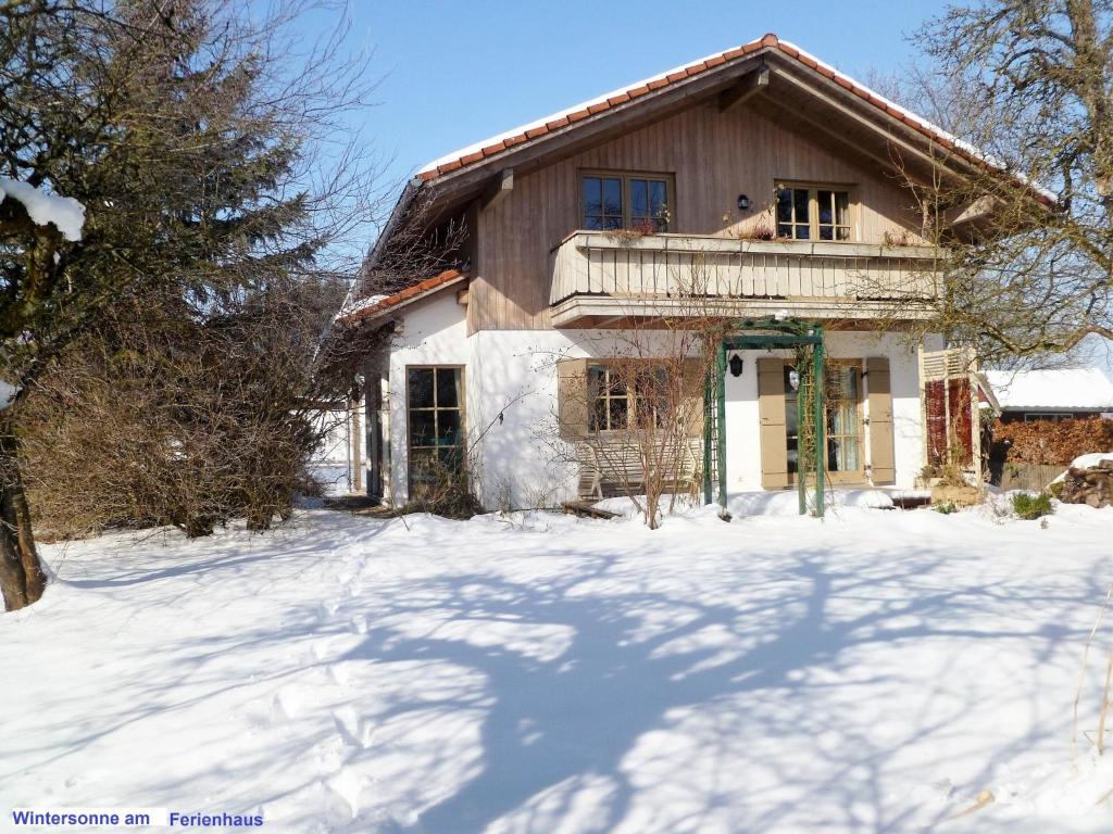dom z balkonem w śniegu w obiekcie Ferienhaus Graziadei w mieście Grassau