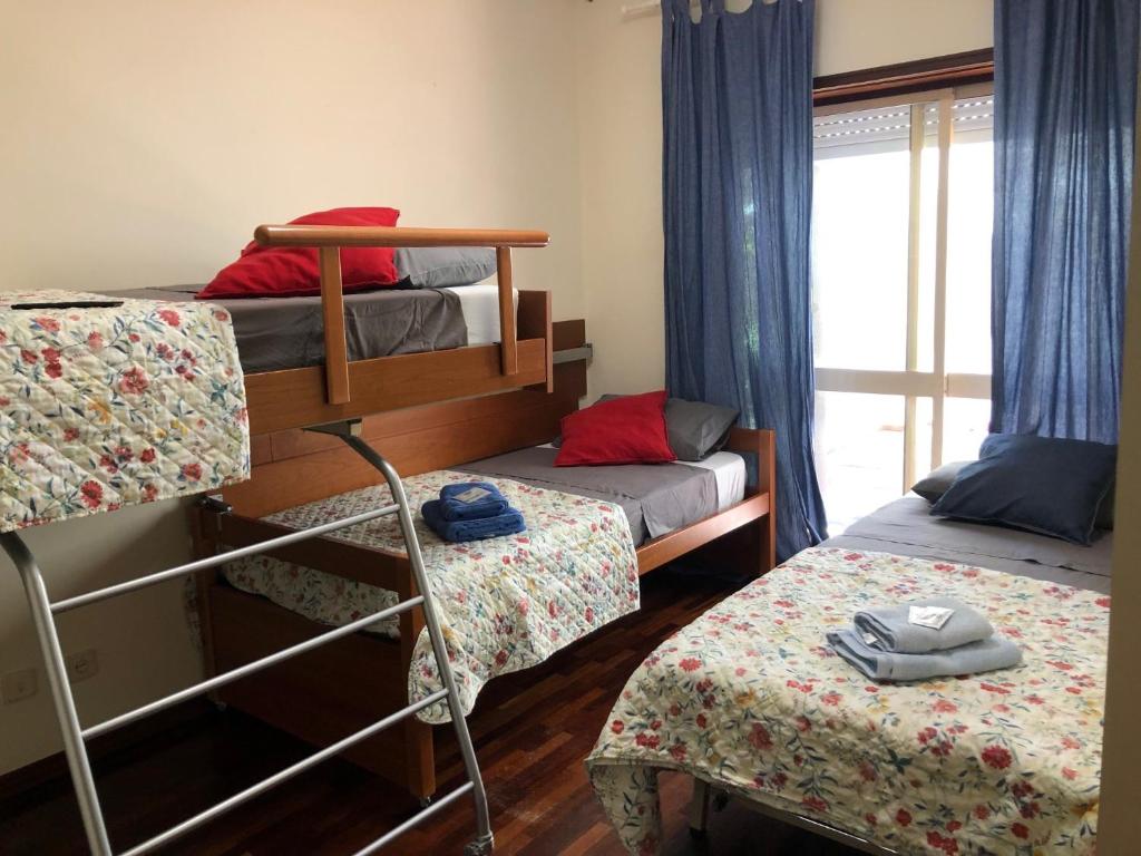 a bedroom with two bunk beds and a window at Castelo do Relógio by Férias em Figueira in Figueira da Foz
