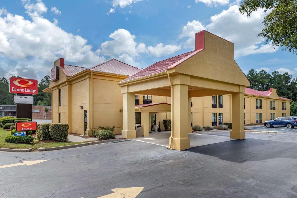 a hotel building with a for lease sign in a parking lot at Econo Lodge in Saint Stephen