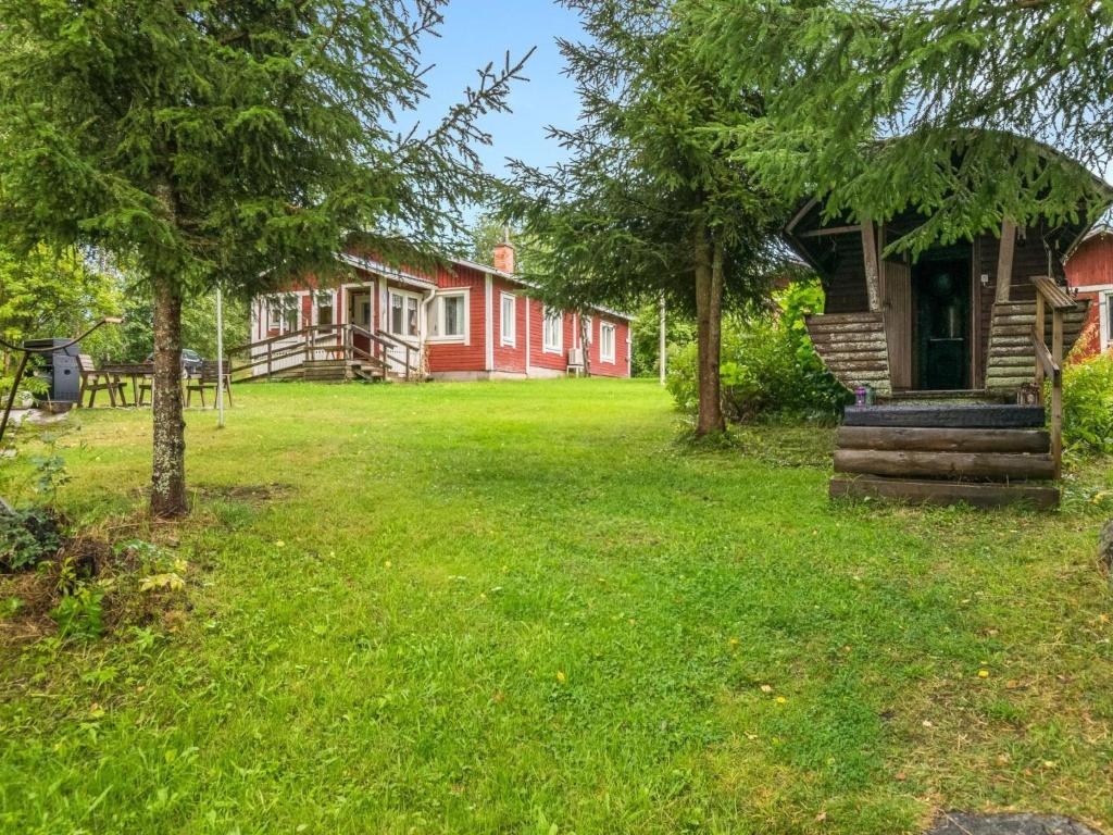 a home with a yard with trees and a house at Holiday Home Matkonranta by Interhome in Kerimäki