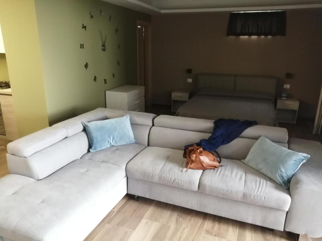 a couch with a dog laying on it in a living room at Etna relax in Zafferana Etnea
