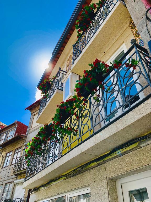 a building with balconies with flowering plants on it at BF Suites & Apartments in Porto