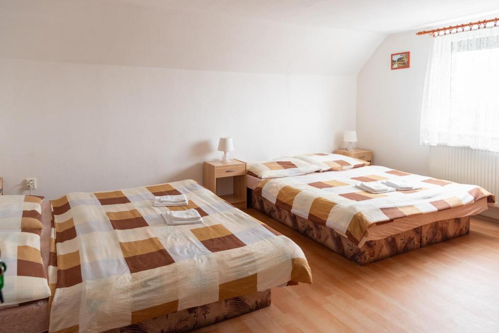 Postel nebo postele na pokoji v ubytování Podhájska - Apartmány Pod Orechom