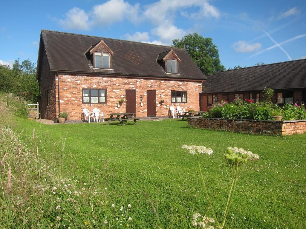 a brick house with a lawn in front of it at Lower Micklin Farm in Alton