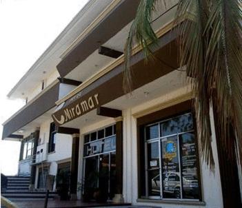 a building with a sign for a shop at Hotel Miramar - La Paz in La Paz