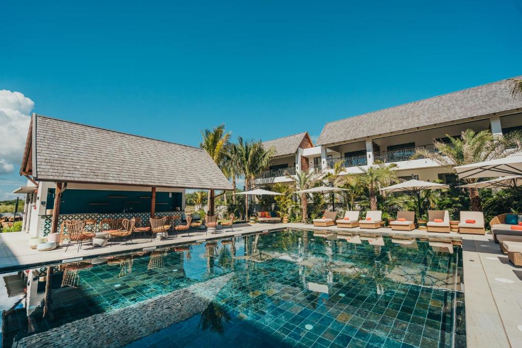 a swimming pool in front of a resort at Domaine de Grand Baie in Grand-Baie