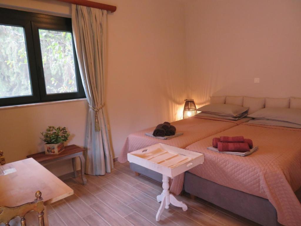 a bedroom with a bed with a table on it at NATURE LODGE, Lily Rose Cottage - close to airport and seaside resort in Markopoulo