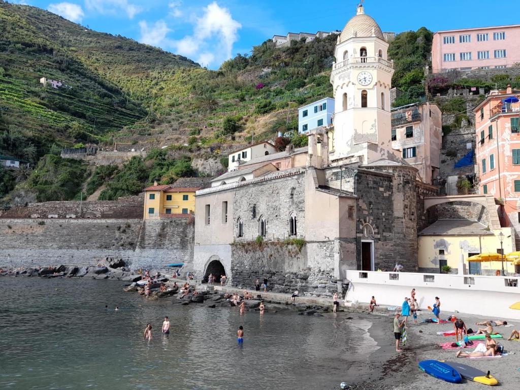 a group of people in the water at a beach at Angilina's apartment in Vernazza