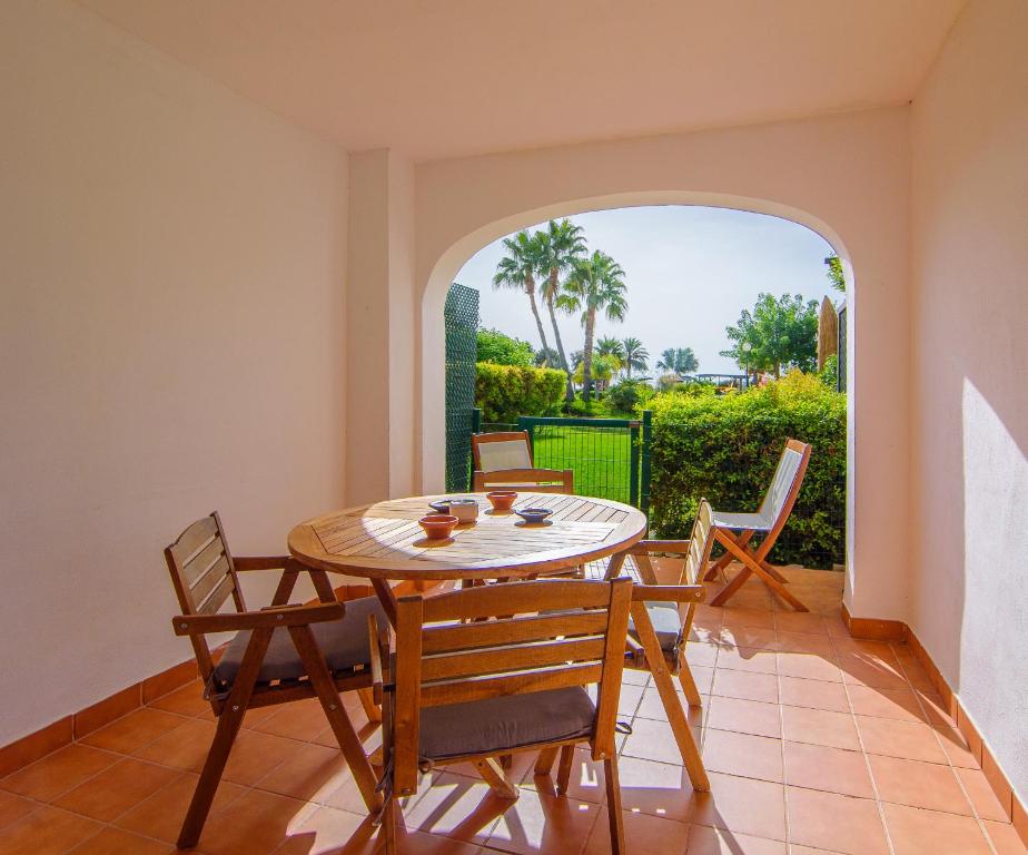 a dining room with a table and chairs at Mediterranea 2 Vera Playa Jardines tus momentos frente al mar in Vera