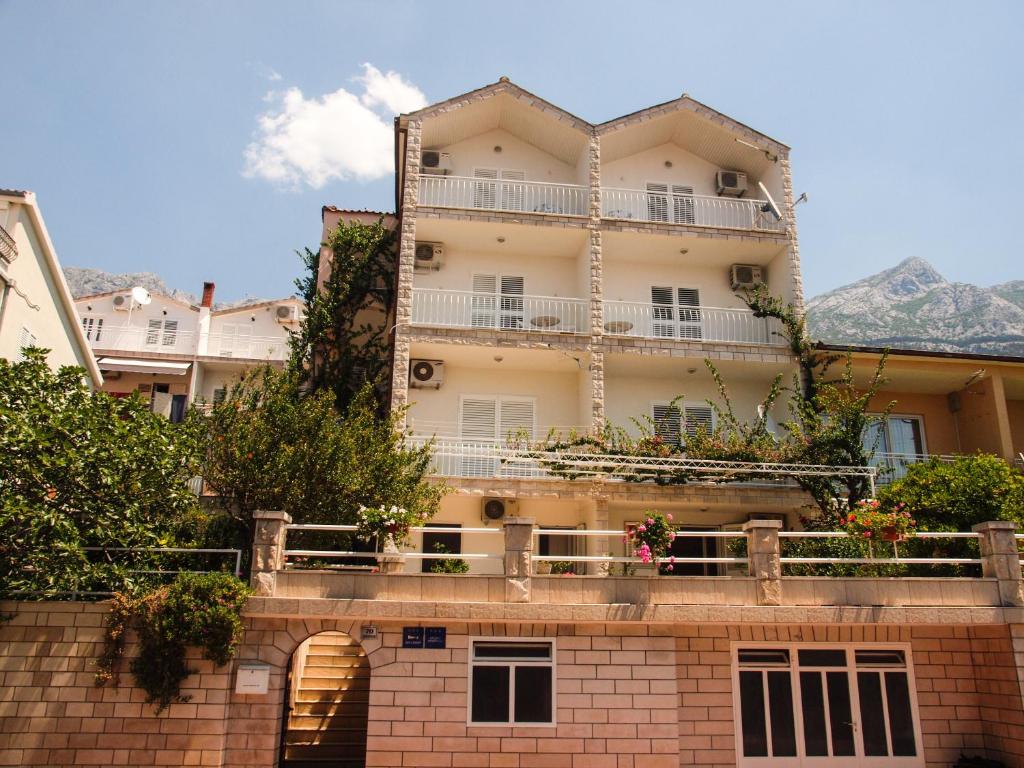 ein Gebäude mit Balkon auf einer Ziegelmauer in der Unterkunft Villa Neda in Makarska